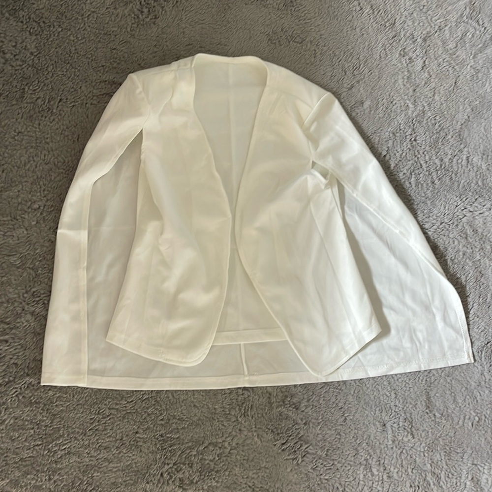White blazer with cape back and shoulder pads inside; worn once for fashion show